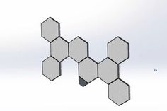 an image of some hexagonal objects floating in the air on a white background