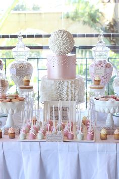 a table topped with lots of cakes and desserts