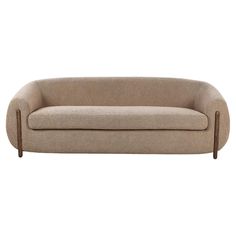 a beige couch sitting on top of a white floor