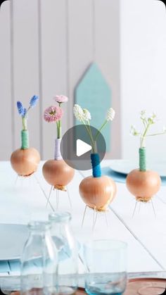 three vases filled with flowers sitting on top of a table