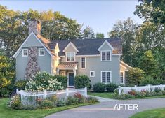 a large house with a white picket fence in front of it