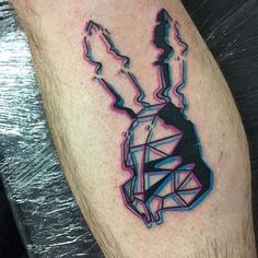 a man's leg with a tattoo on it that has an image of a rabbit