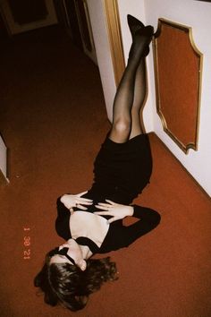 a woman is laying on the floor with her legs spread out and wearing black stockings