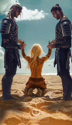 two men and a woman sitting in the sand with their hands on each other's hips