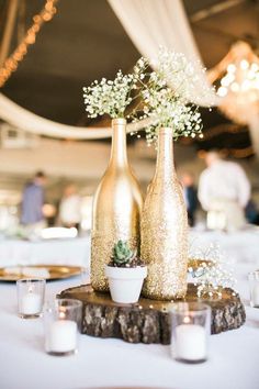 two vases filled with flowers on top of a table