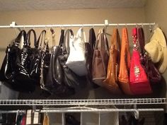 several purses and handbags hanging on a rack