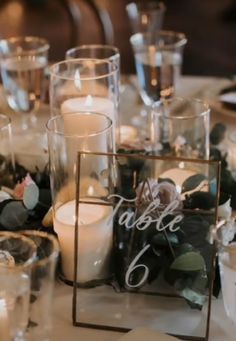 the table is set with candles and place cards