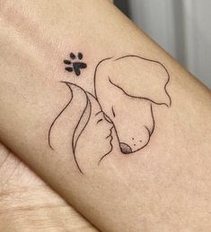 a woman's arm with a dog paw tattoo on it