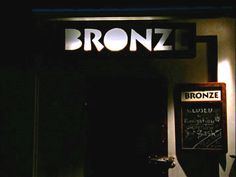 the entrance to bronzo's restaurant at night