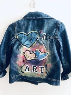 Inspired by my daughter's love of art!This is a thrifted Gap Kids denim jacket in a size 5.I hand painted and spray painted the back and added patches and a cat button to both the front and back.All patches are reinforced by hand stitching. This piece should be hand washed. All jackets are one of a kind. Personalization is free. Artistic Denim Outerwear For Spring, Artsy Cotton Denim Jacket For Spring, Blue Denim Jacket With Custom Artwork For Spring, Artistic Cotton Spring Outerwear, Artistic Cotton Outerwear For Spring, Spring Artistic Denim Jacket With Custom Artwork, Artistic Denim Jacket With Custom Artwork For Spring, Artistic Fitted Denim Jacket For Spring, Artistic Hand Painted Fitted Denim Jacket