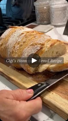 a loaf of bread is being cut on a cutting board