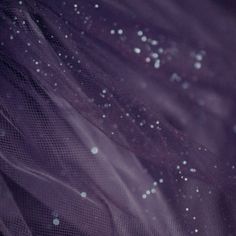 the fabric is purple and has white dots on it