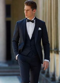 a man in a tuxedo is walking down the street