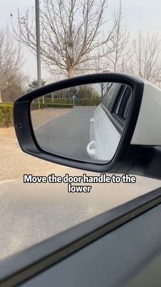 there is a rear view mirror with the words move the door handle to the left