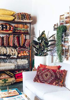 a living room filled with lots of pillows and furniture