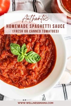 homemade spaghetti sauce in a white bowl with basil leaves on top and tomatoes around it