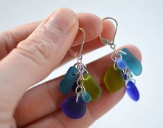 These blue and green sea glass earrings are made with high-quality frosted glass that resembles ocean tumbled sea glass, but is much cheaper, comes in vibrant colors, and is consistent in shape and size. The shape of the glass pieces may vary, but the color and style will be consistent. I make these sea glass earrings with sterling silver materials and ear wires. You can select your preference from the drop-down menu: I offer regular hooks (also called French hooks) and lever backs. You can see Sea Glass Earrings Diy, Beach Glass Earrings, Sea Glass Jewelry Diy, Sea Glass Crafts Jewellery, Sea Glass Keychain, Seaglass Beach, Sea Glass Diy, Sea Glass Gifts, Sea Glass Art Diy