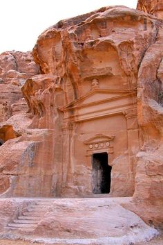 an ancient building carved into the side of a mountain