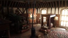 an old fashioned living room with wood paneling and arched windows in the ceiling, along with antique furniture