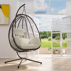 a hanging egg chair in an empty room