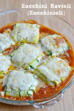 zucchini ravioli and zucchini sauce in a glass dish on a wooden table