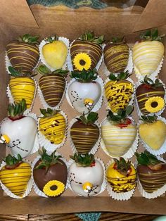 chocolate covered strawberries with sunflowers and other decorations in a cardboard box on the table