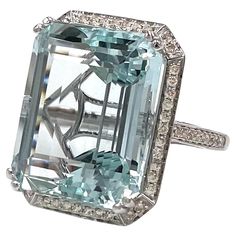 An everyday statement! This 14K white gold ring features a spectacular step cut aquamarine weighing 23.93 carats. The ring is furnished with an additional 62 round diamonds weighing a total of 0.52 carat (H/I color, SI clarity). 1950s Engagement Ring, Kelsey Rose, Bijoux Art Deco, Platinum Diamond Rings, Gold Cocktail Ring, Bling Rings, Bijoux Diy, Cluster Ring, White Gold Rings