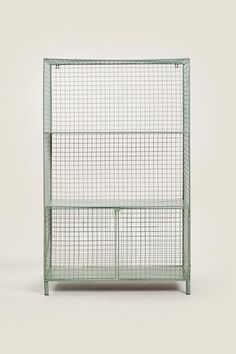 a green metal shelf with three shelves on each side and two doors at the top