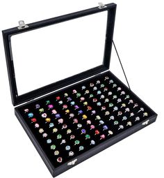 an open black box filled with lots of different colored rings in it's lid