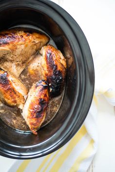 some chicken in a crock pot on a table