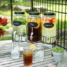 four mason jars filled with drinks on top of a wooden table