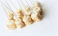 white and gold sprinkles are arranged on top of marshmallows