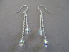 These sparkly earrings have 9x6mm clear Austrian crystal teardrops with an AB finish wire wrapped onto different lengths of sparkly sterling silver Singapore rope chain, hanging from sterling silver ear wires. The length is 2" from the ear wire loop. The AB stands for aurora borealis, a colorful rainbow finish. Pumpkins Crafts, Diy Pumpkins Crafts, Diy Pumpkins, Crystal Teardrop Earrings, Sparkly Earrings, Colorful Rainbow, Earrings Long, Austrian Crystal, Rope Chain