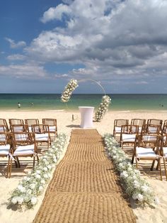 an outdoor ceremony setup on the beach