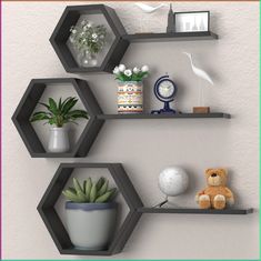 three hexagonal shelves with plants and decorations on them