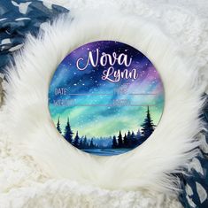 an ornament with the words aurora lynn on it and trees in the background