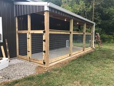 a large chicken coop in front of a building