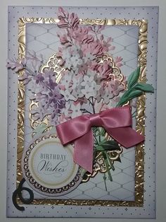 a close up of a greeting card with flowers on it and a ribbon tied around the front