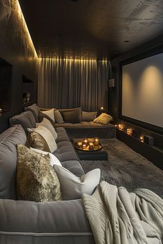 a living room filled with lots of couches next to a wall mounted projector