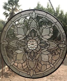 a circular stained glass window hanging from a chain