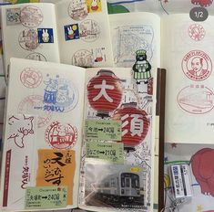 an open book with various stamps and stickers on the pages, including a train