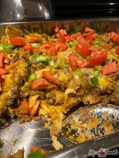 a large metal pan filled with food on top of a table