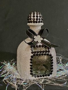 the bottle is decorated with black and white beads