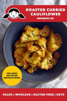 roasted cauliflower in a blue bowl on a white tablecloth with the title, roasted currie cauliflower