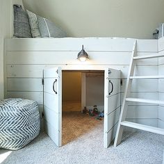 there is a bunk bed in the corner of this room with a ladder to it