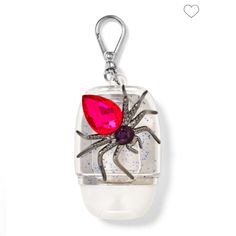 a spider charm with a red heart on it's back