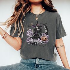 Embrace your spooky side with our 'Feeling Witchy' T-Shirt featuring a detailed gothic witch artwork. Perfect for Halloween festivities, this shirt showcases a witch with a hat, crescent moon, bats, and a pumpkin, making it a must-have for the season. Ideal for anyone who loves witchy vibes, gothic themes, or Halloween costumes. A great addition to any wardrobe for a fun and festive look. Product Features: Fabrication: Medium fabric (6.1 oz/yd² (206.8 g/m. Garment-dyed fabric. 100% ring-spun cotton Fit: Relaxed fit Sizing: Unisex Sizing Label: Sewn-in twill label Witch Hat Costume, Witch Artwork, Witch Hats Costume, Pumpkin Moon, Gothic Artwork, Bat Shirt, Gothic Themes, Gothic Witch, Halloween Festivities