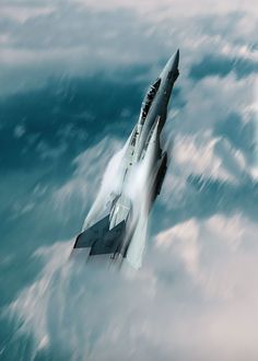 a fighter jet flying through the air above clouds in the ocean with water splashing around it