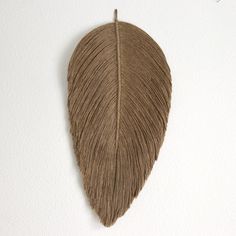 a brown leaf hanging on the wall