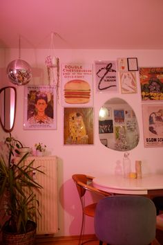 a dining room with posters on the wall